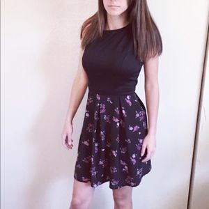 A dress mid-length. Black with some floral patten.